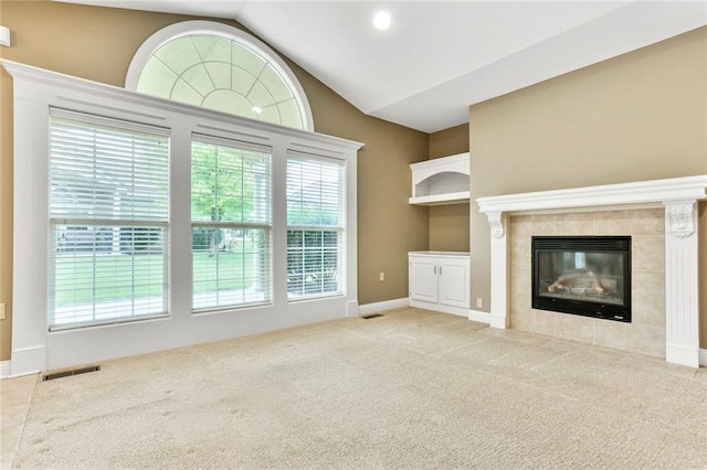 5428 W 145th Ter, Leawood, KS 66224 - unfurnished living room featuring a tile fireplace, carpet, vaulted ceiling, and baseboards