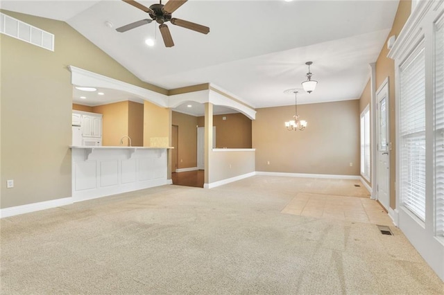 5428 W 145th Ter, Leawood, KS 66224 - unfurnished living room featuring a chandelier, light carpet, ceiling fan, baseboards, and vaulted ceiling