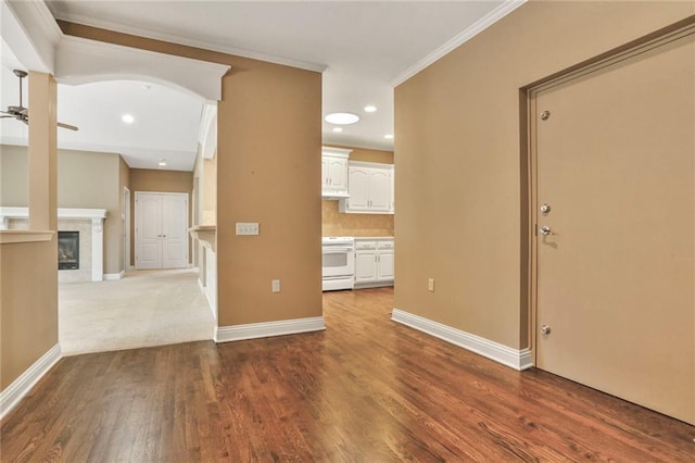 5428 W 145th Ter, Leawood, KS 66224 - unfurnished living room with ornamental molding, dark wood finished floors, baseboards, a ceiling fan, and recessed lighting