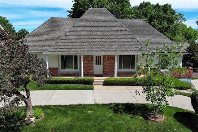 view of front of house with brick siding and a front lawn