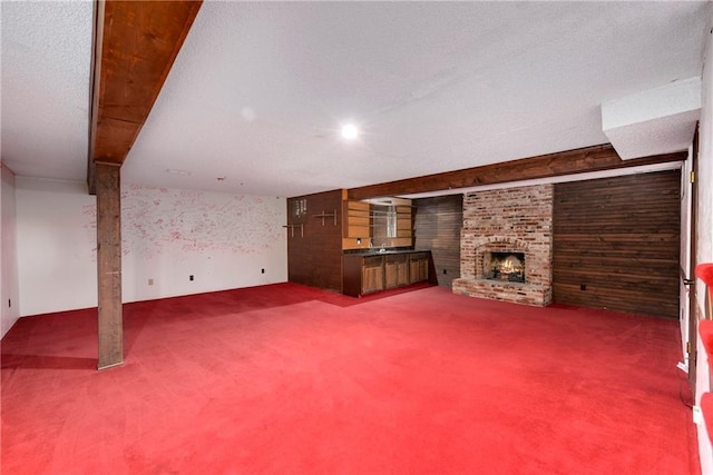 unfurnished living room with carpet and a brick fireplace