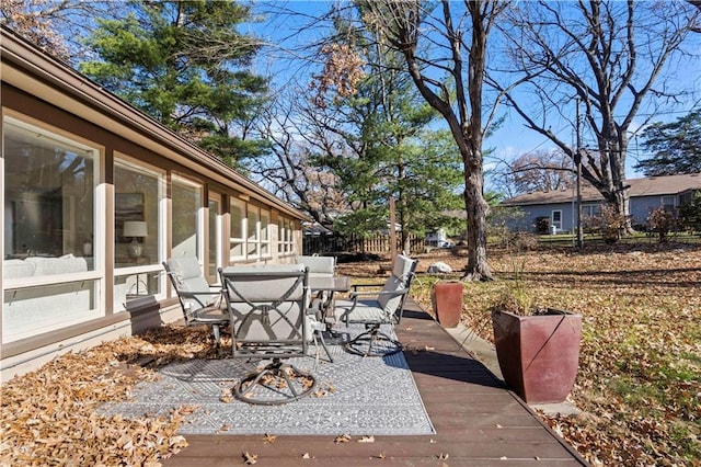 view of patio / terrace featuring outdoor dining space and a sunroom