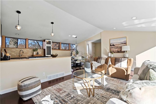 living area featuring visible vents, baseboards, recessed lighting, wood finished floors, and lofted ceiling