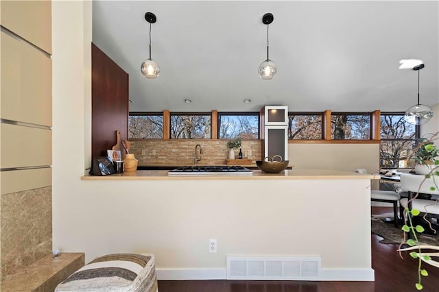 kitchen with visible vents, pendant lighting, wood finished floors, and a healthy amount of sunlight