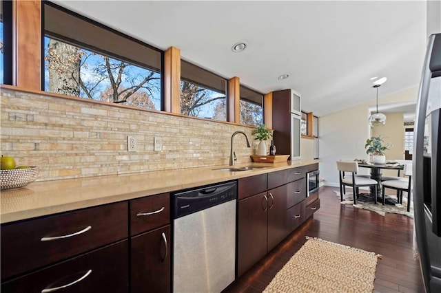 kitchen featuring a sink, light countertops, decorative backsplash, and stainless steel appliances