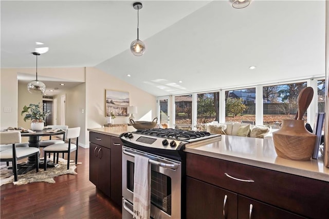 kitchen featuring dark wood-style flooring, light countertops, dark brown cabinets, stainless steel gas stove, and lofted ceiling