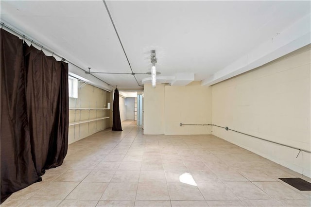 basement with light tile patterned floors and visible vents