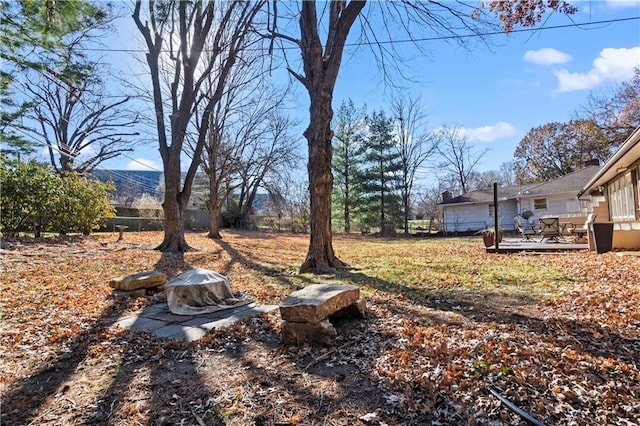 view of yard featuring fence and a wooden deck