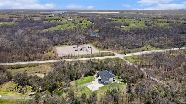 birds eye view of property featuring a wooded view