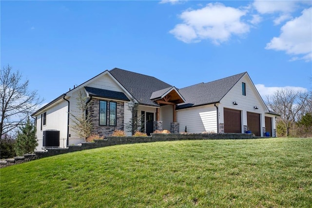 view of front of property featuring a garage, cooling unit, a front lawn, and stone siding