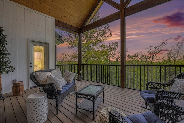 deck at dusk featuring an outdoor hangout area