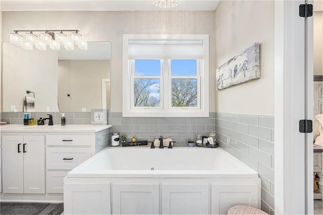 bathroom featuring vanity and a bath
