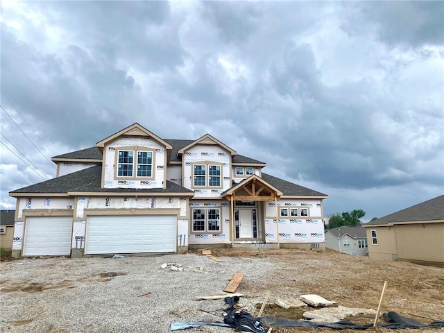 property under construction featuring a garage and a shingled roof