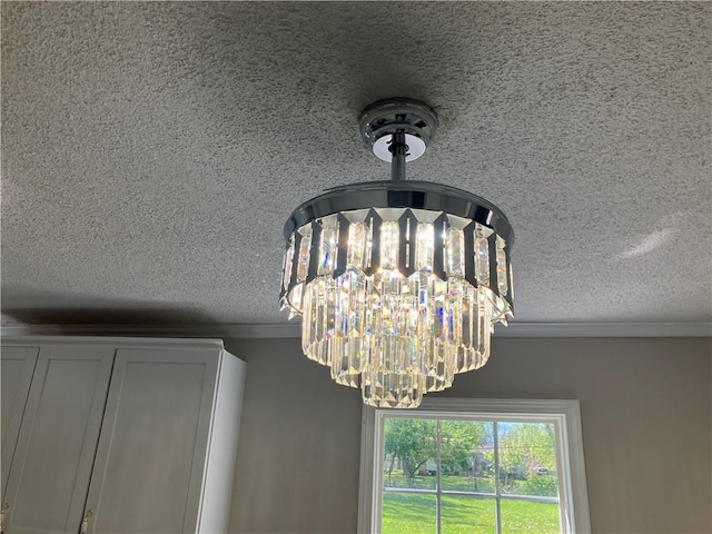 detailed view of a textured ceiling, ornamental molding, and a chandelier
