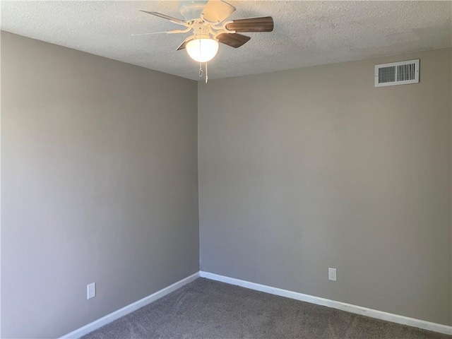 unfurnished room featuring a ceiling fan, dark colored carpet, baseboards, and a textured ceiling
