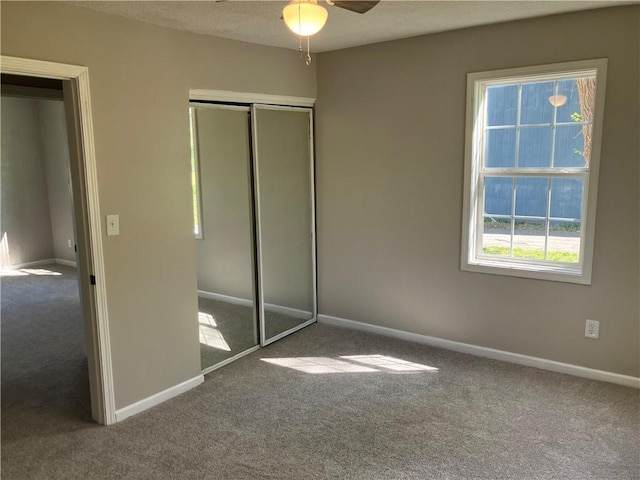 unfurnished bedroom featuring carpet flooring, a closet, and baseboards