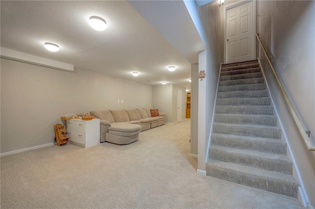 stairway featuring a textured ceiling, baseboards, and carpet floors