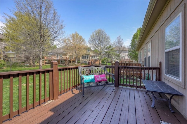wooden terrace featuring a yard