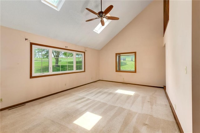 32832 195th St, Leavenworth, KS 66048 - carpeted empty room with a skylight, high vaulted ceiling, ceiling fan, and baseboards