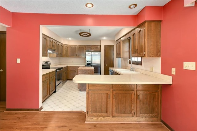 32832 195th St, Leavenworth, KS 66048 - kitchen featuring range with electric stovetop, a sink, stainless steel refrigerator with ice dispenser, a peninsula, and light countertops