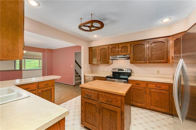 32832 195th St, Leavenworth, KS 66048 - kitchen featuring stainless steel appliances, under cabinet range hood, light floors, wooden counters, and recessed lighting