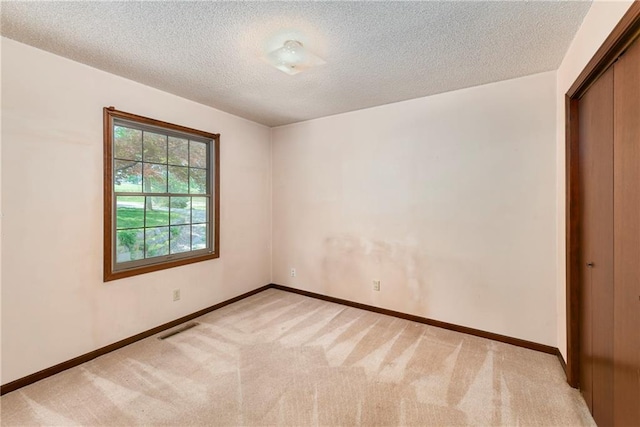 32832 195th St, Leavenworth, KS 66048 - empty room featuring light colored carpet, a textured ceiling, and baseboards