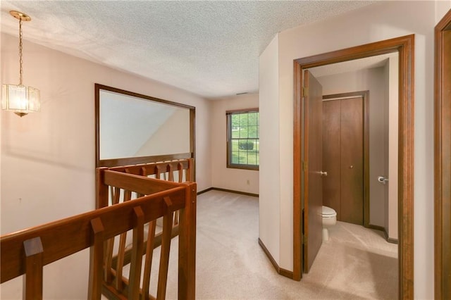 32832 195th St, Leavenworth, KS 66048 - hallway featuring an upstairs landing, light colored carpet, a textured ceiling, baseboards, and a chandelier
