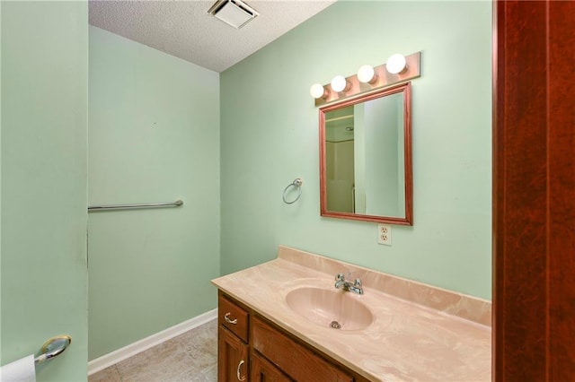 32832 195th St, Leavenworth, KS 66048 - bathroom with a textured ceiling, vanity, and baseboards