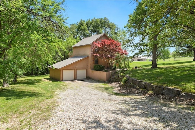 32832 195th St, Leavenworth, KS 66048 - view of side of home with a lawn, driveway, and a garage