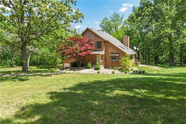 32832 195th St, Leavenworth, KS 66048 - rear view of property with a chimney, a lawn, and a garage