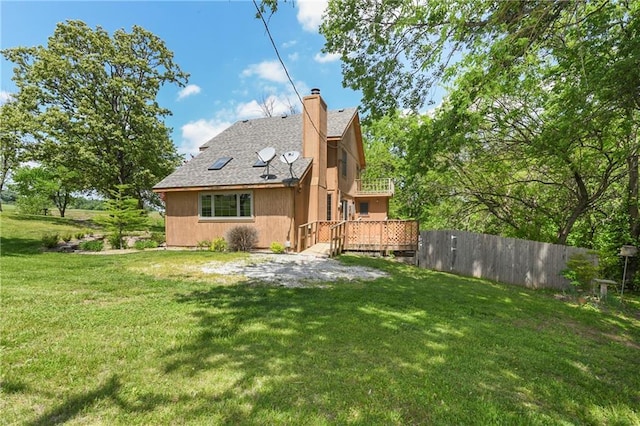 32832 195th St, Leavenworth, KS 66048 - back of house with a chimney, a wooden deck, and roof with shingles