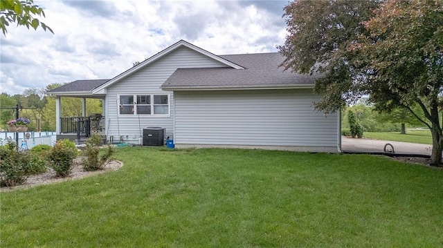 15404 NE 181st St, Holt, MO 64048 - rear view of property featuring a lawn, central AC unit, and roof with shingles