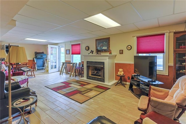15404 NE 181st St, Holt, MO 64048 - living room featuring a fireplace with raised hearth, wood finished floors, and a paneled ceiling