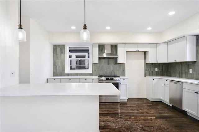 3009 Campbell St, Kansas City, MO 64109 - kitchen featuring tasteful backsplash, a peninsula, wall chimney exhaust hood, dark wood finished floors, and stainless steel appliances