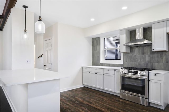 3009 Campbell St, Kansas City, MO 64109 - kitchen featuring dark wood finished floors, light countertops, stainless steel gas range oven, wall chimney exhaust hood, and decorative backsplash