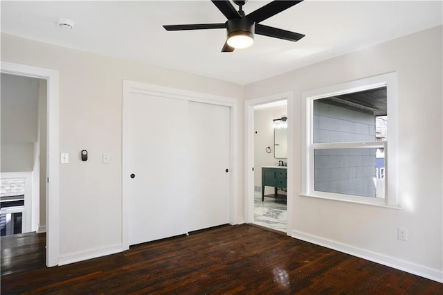 3009 Campbell St, Kansas City, MO 64109 - unfurnished bedroom with a closet, baseboards, ceiling fan, and dark wood finished floors