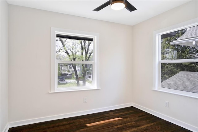 3009 Campbell St, Kansas City, MO 64109 - spare room with a ceiling fan, baseboards, dark wood finished floors, and a wealth of natural light