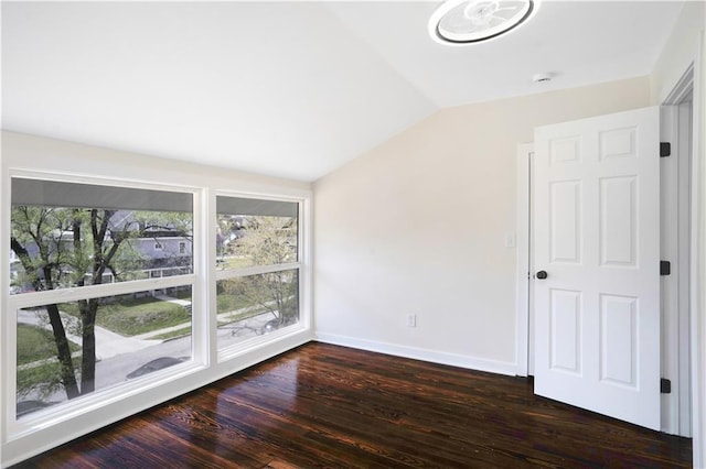 3009 Campbell St, Kansas City, MO 64109 - spare room featuring dark wood-style floors, baseboards, vaulted ceiling, and a healthy amount of sunlight