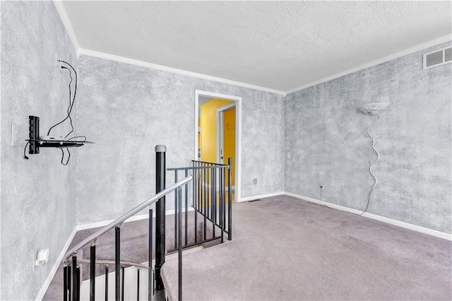 unfurnished room featuring crown molding and a textured ceiling