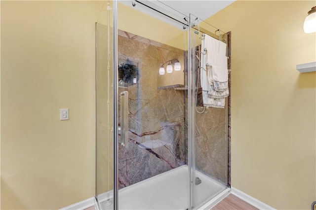 full bath with baseboards and a stall shower