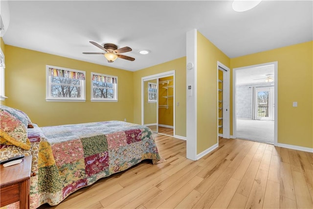 bedroom with baseboards, a ceiling fan, and wood finished floors