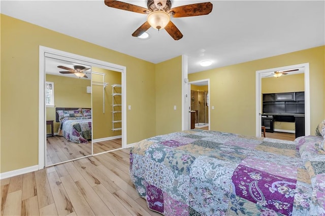 bedroom featuring ceiling fan, a closet, baseboards, and wood finished floors