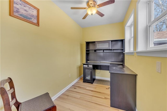 office featuring light wood-type flooring, baseboards, and ceiling fan
