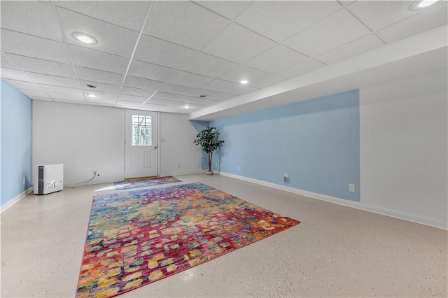 below grade area featuring baseboards, recessed lighting, and a paneled ceiling
