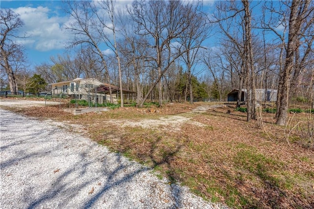 view of yard featuring gravel driveway and a vegetable garden