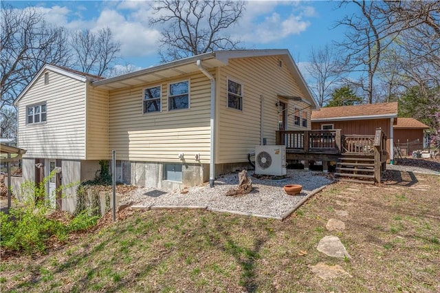 rear view of house featuring ac unit and a wooden deck