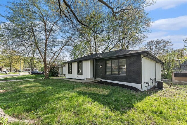 710 N Redwood Dr, Independence, MO 64056 - exterior space with brick siding, fence, cooling unit, and a front yard