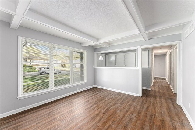 710 N Redwood Dr, Independence, MO 64056 - empty room with beamed ceiling, wood finished floors, baseboards, and coffered ceiling
