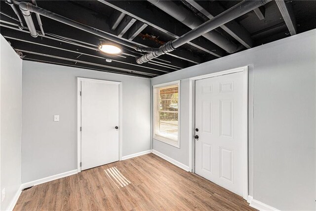 710 N Redwood Dr, Independence, MO 64056 - basement featuring light wood-style floors and baseboards