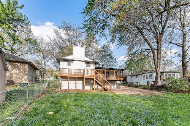 710 N Redwood Dr, Independence, MO 64056 - rear view of house with stairway, a chimney, a fenced backyard, a yard, and a deck